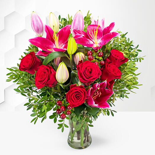 You   I: 1 Pink Lily, 10 Red Roses, 5 Red Hypericum   Seasonal Greens