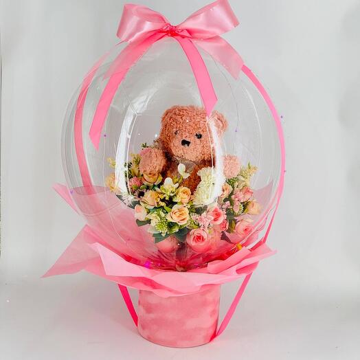 Gift packaging Bubble box Bubble box with artificial flowers and a soft teddy bear