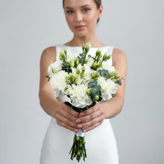 Delicate white bridal bouquet of lisianthus, carnation and eucalyptus