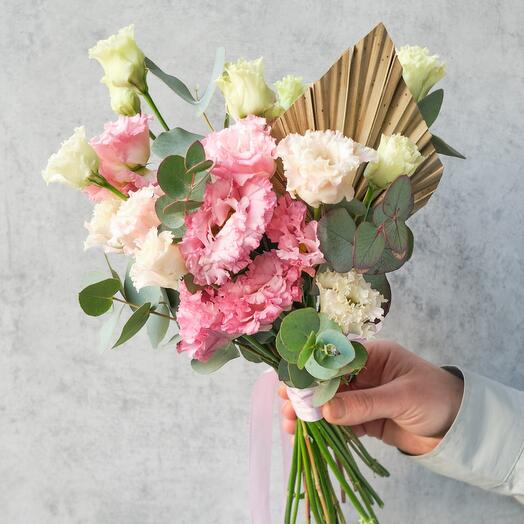 Pink bridal bouquet made of openwork eustoma, eucalyptus and palm leaves