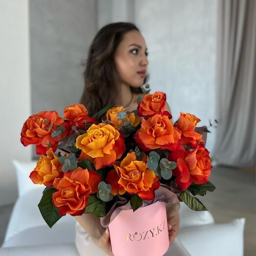 Composition in a box with eucalyptus and roses