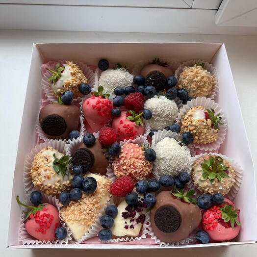 Berry set of strawberries, bananas, raspberries and blueberries in chocolate