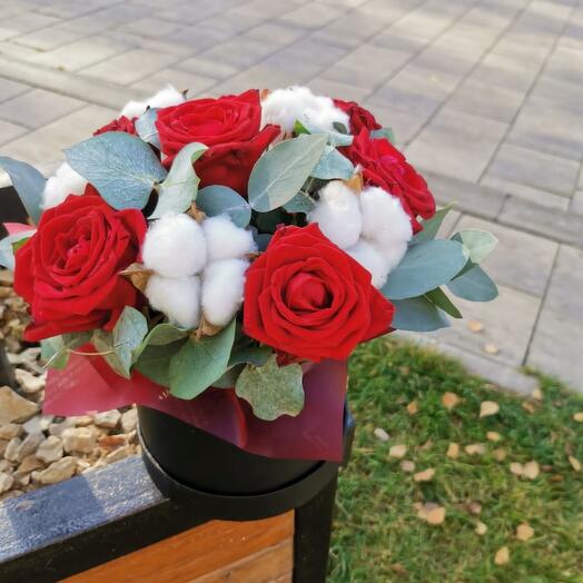 A box with cotton and a burgundy rose