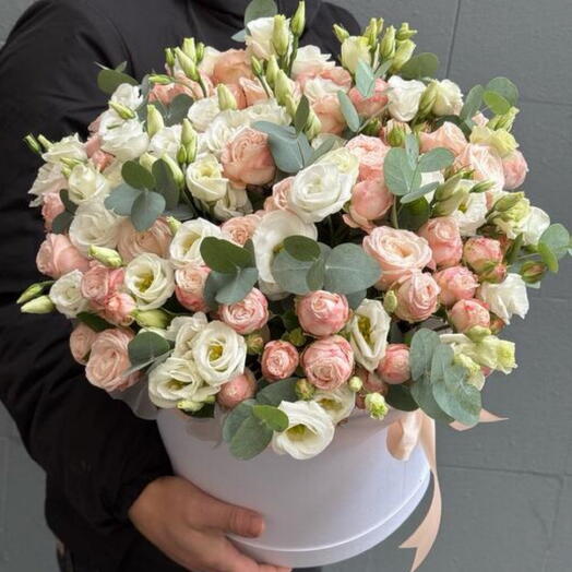 A delicately assembled bombastic roses with lisianthus and eucalyptus