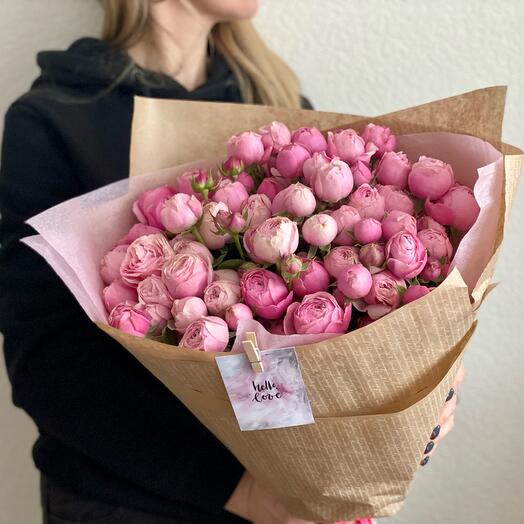 An armful of bushy peony-shaped roses