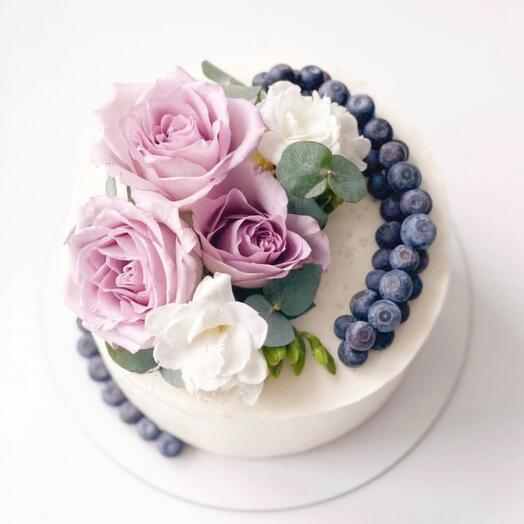 Cake with edible flowers and blueberries