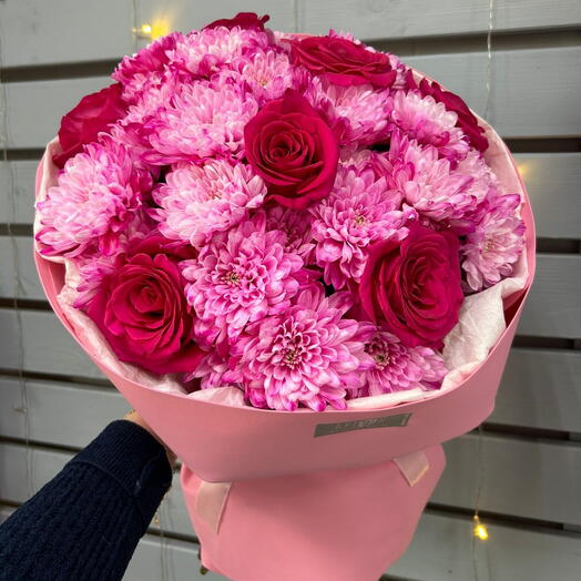 A large bright bouquet of roses and chrysanthemums