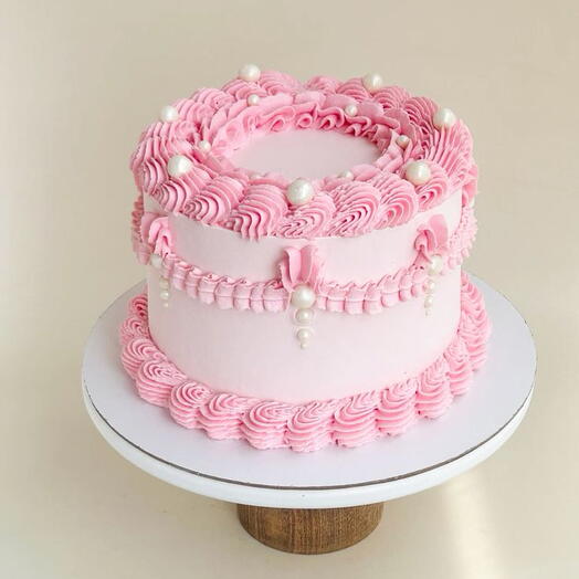 Light baby pink + white bets vintage Birthday cake