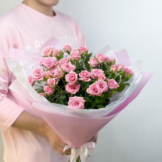 Delicate bouquet of pink bush roses in a pink package