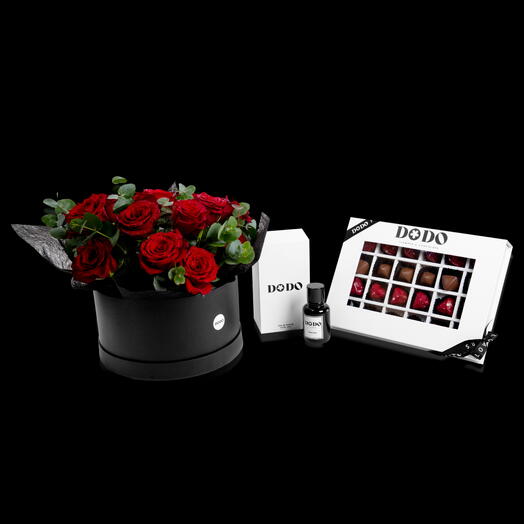 Flowers in a box with chocolate and perfume