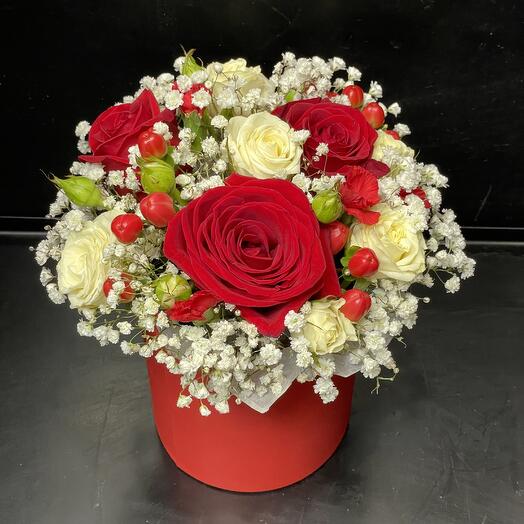 Floral arrangement in a gift bag with roses, gypsophila