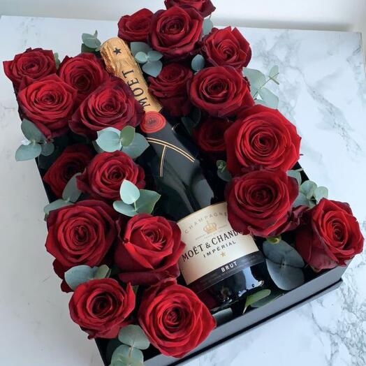 Flowers in a box with sparkling wine