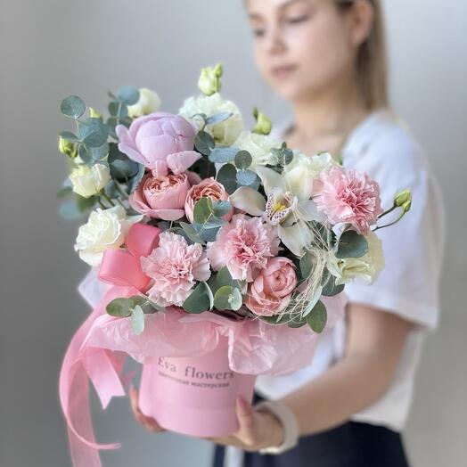 Delicate flowers in a box with a peony