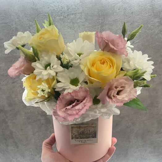 Flowers in a box with a postcard