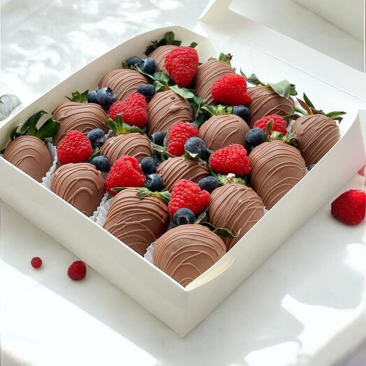 Chocolate-covered strawberries with raspberries and blueberries