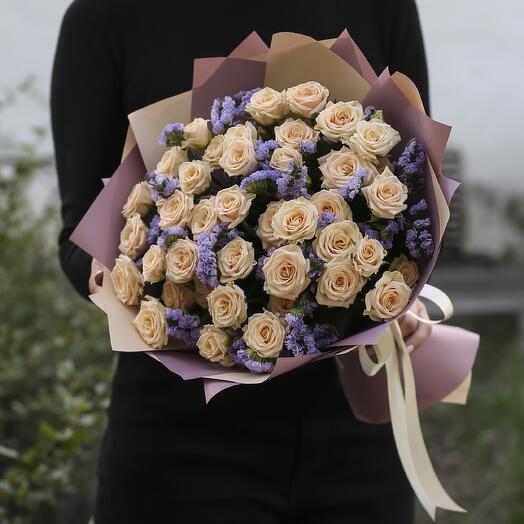 Bouquet of 11 cream bush roses with statice in designer packaging