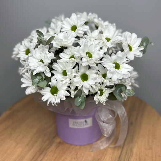 Flowers in a box chrysanthemum chamomile with eucalyptus