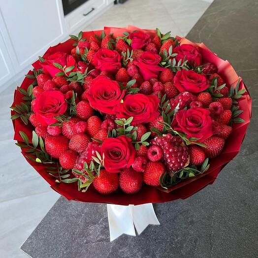 Bouquet of strawberries, raspberries, pomegranate and roses