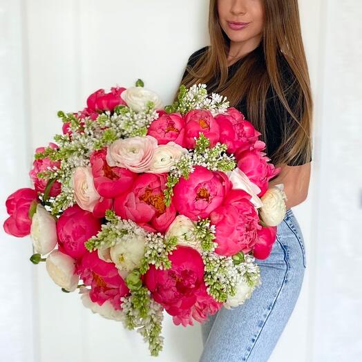 Bouquet of coral charm peonies, ranunculus and white lilac