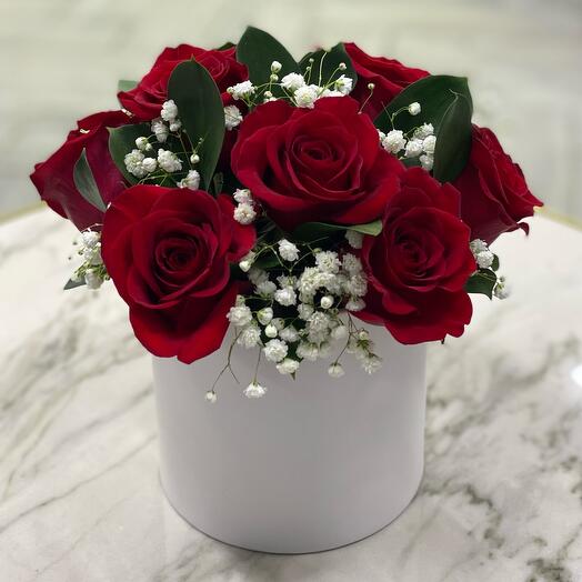 A box with red roses and gypsophila