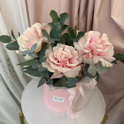 French roses with eucalyptus in a box