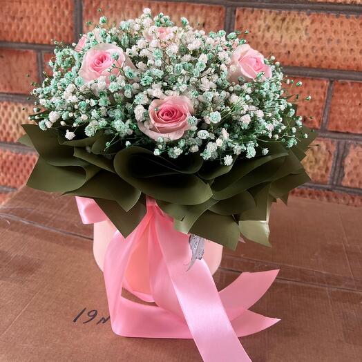 Flowers in a box with a pink rose
