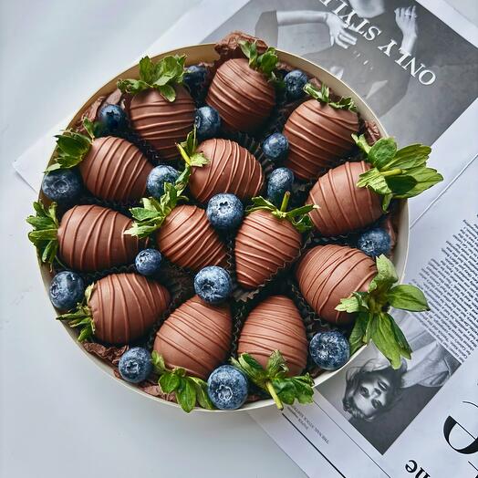Strawberries in milk Belgian chocolate with blueberries in a beautiful round box