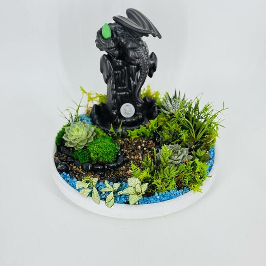 Table arrangement of succulents with a glowing dragon and incense