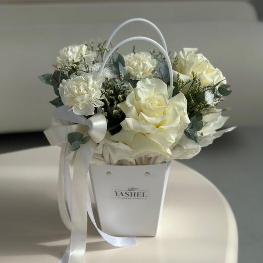 White handbag with delicate roses, dianthus and limonium