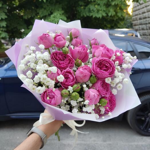 Bouquet of bushy peony-shaped roses with gypsophila