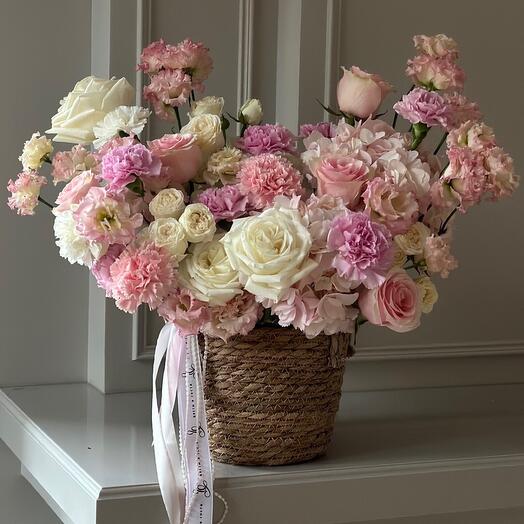 A delicate arrangement of flowers in a jute planter