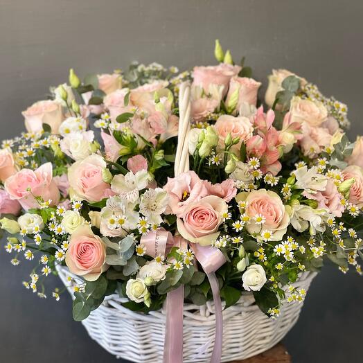 Basket with flowers in pink shades