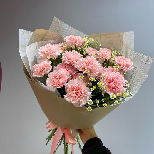 Delicate bouquet of 15 pink carnations with chamomile in a package