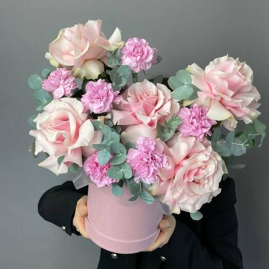 Pink roses with pink carnations and eucalyptus in a box