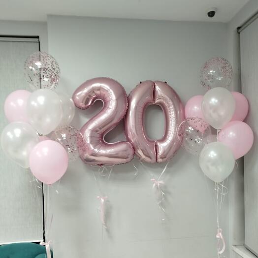 A set of balloons inflated with helium pink numbers