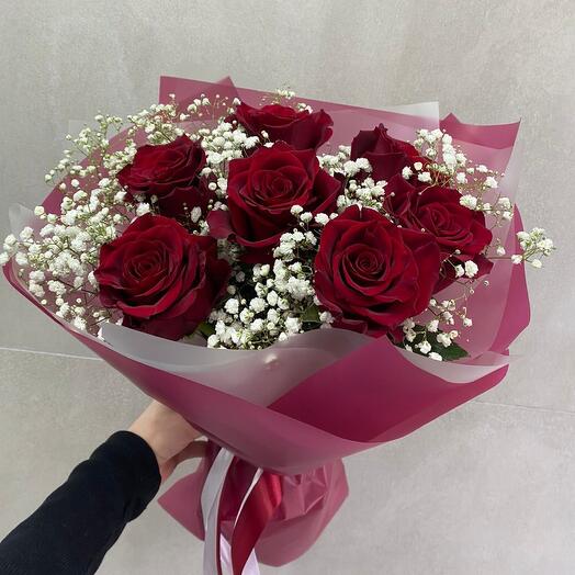 Bouquet of red roses and airy gypsophila