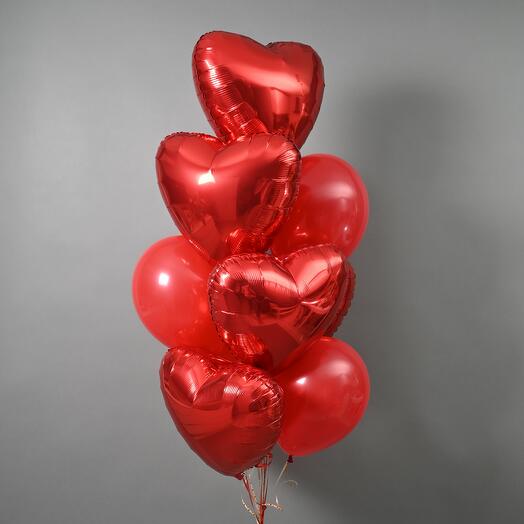 A set of helium balloons made of red hearts and latex balloons red