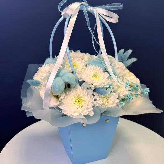 Composition in a handbag with blue cotton