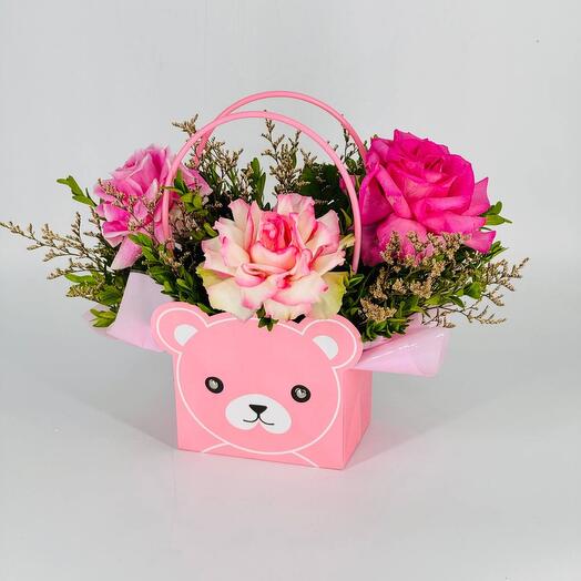 Flowers French roses in a teddy bear handbag