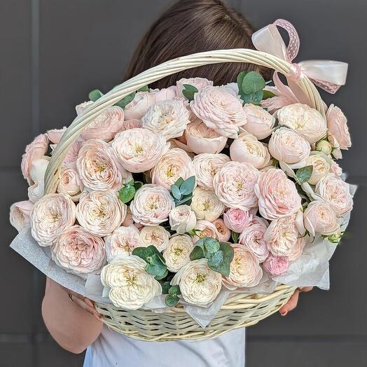 Basket with peony-shaped roses and eucalyptus