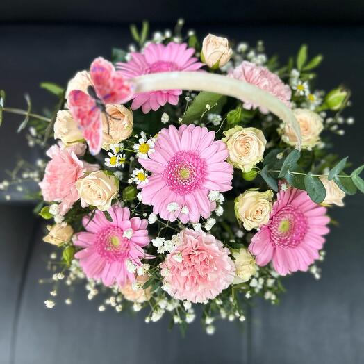 Basket with gerbera, dianthus and bush rose