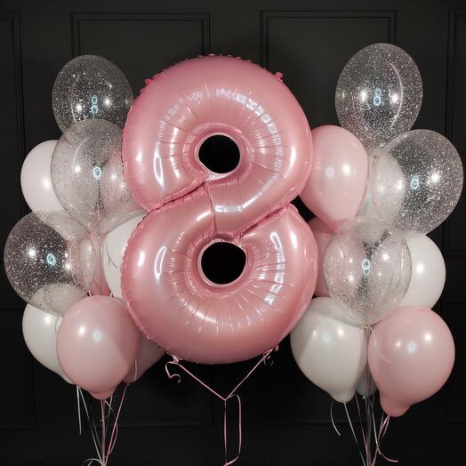 Composition of white pink and transparent balls with a pink number