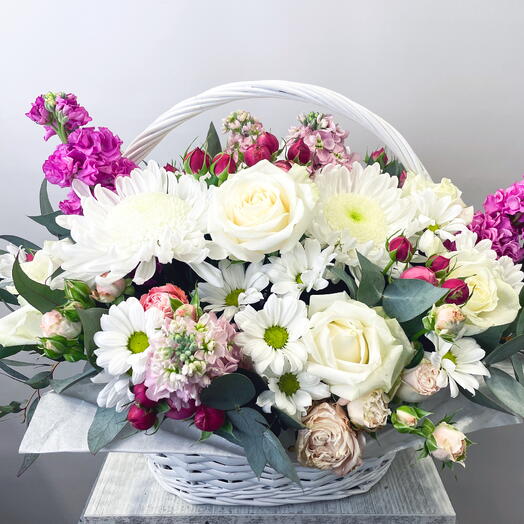 A basket of pink and white flowers