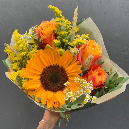 A compliment bouquet with sunflowers, red and yellow roses, Silantha, daisies, solidaga, trinicum and decorative greenery