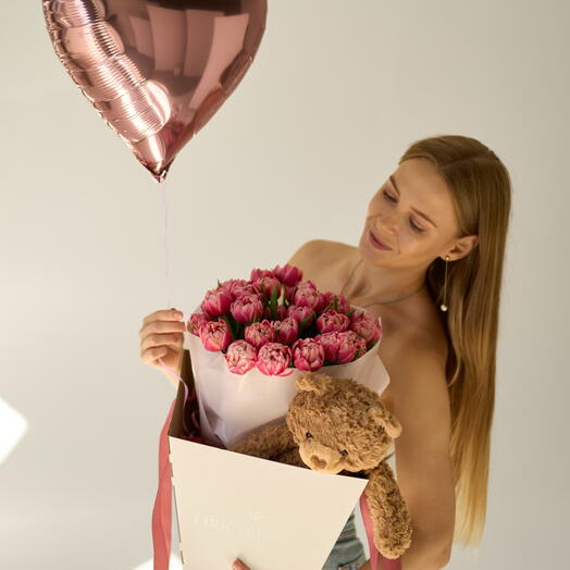 Bright pink tulips with a soft toy