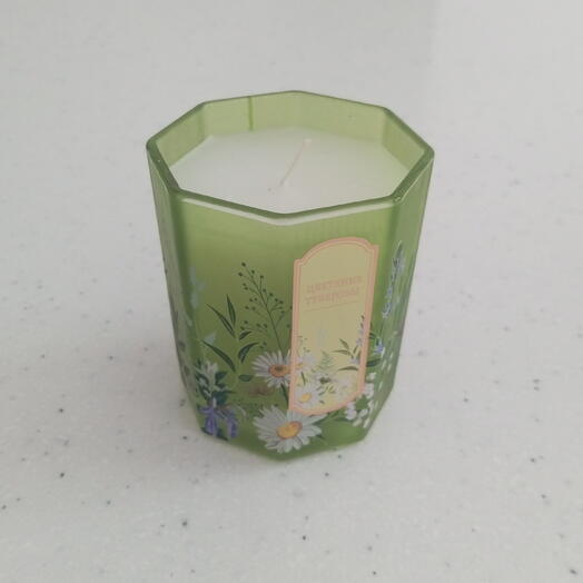 A cube-shaped paraffin candle with an ethnic-style ornament