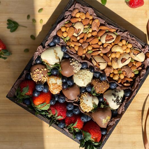 Box with chocolate-covered strawberries, nuts, blueberries and classic berries (strawberries)