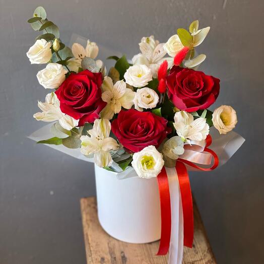 Red roses and white eustoma in a beautiful bouquet in a box