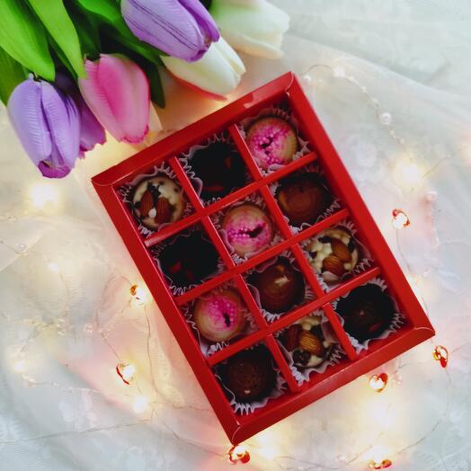 Chocolates, three chocolates,with berries and nuts, love,otters, as a gift