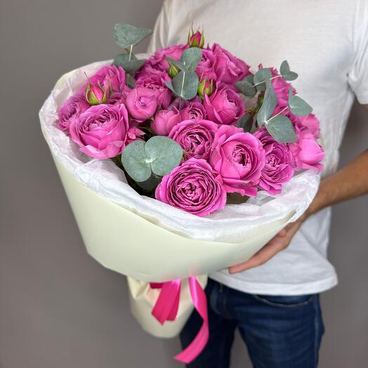 A bright bouquet of peony-shaped roses with eucalyptus